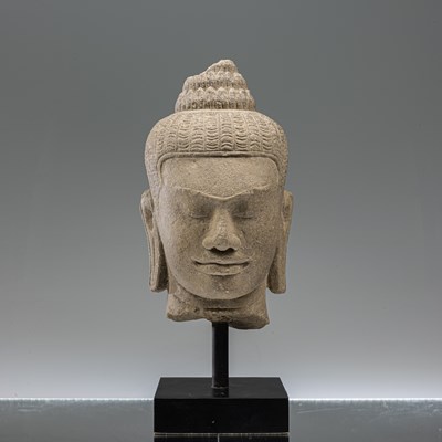 Lot 17 - SANDSTONE BAYON STYLE BUDDHA HEAD SOUTH-EAST ASIA 10TH CENTURY