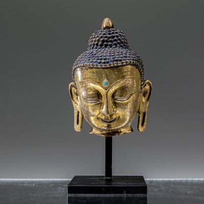 Lot 100 - BRONZE FIREGILT HEAD WITH SILVER AND COPPER INLAYS NEPAL 17TH CENTURY