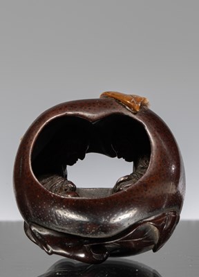 Lot 242 - NETSUKE OF A POMEGRANATE WITH INTERIOR CARVING OF A COUPLE