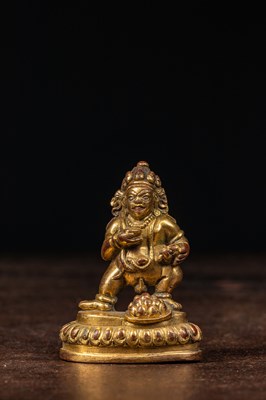 Lot 135 - A GILT-BRONZE FIGURE OF JAMBHALA TIBET 18TH CENTURY