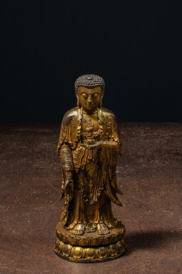 Lot 219 - A GILT-BRONZE BUDDHA HOLDING A VASE CHINA LATE MINGY DYNASTY