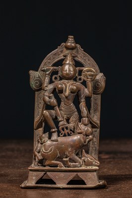 Lot 83 - A BRONZE FIGURE OF DURGA SLAYING THE BUFFALO DEMON (MAHIṢĀSURAMARDINĪ) INDIA 17TH CENTURY