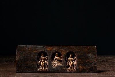 Lot 182 - A WOOD BOOK COVER WITH THREE DIVINE FIGURES TIBET 17TH CENTURY