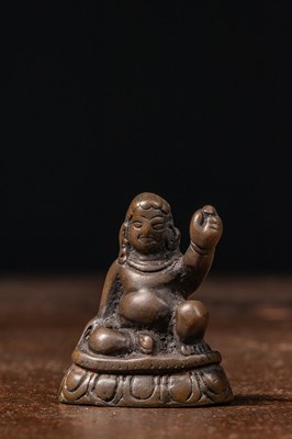 Lot 73 - A MINIATURE BRONZE FIGURE OF A MAHASIDDHA, PROBABLY VIRŪPA TIBET 13TH CENTURY