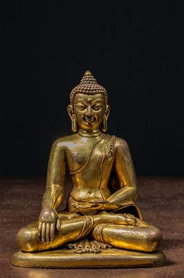 Lot 80 - A GILT BRONZE FIGURE OF BUDDHA IN PĀLA REVIVAL STYLE TIBET 18TH CENTURY