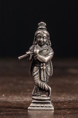 Lot 53 - (R) A SILVER FIGURE OF STANDING KRISHNA PLAYING THE FLUTE INDIA 19TH CENTURY