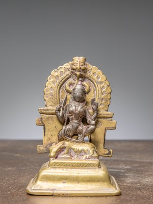 Lot 309 - A SILVER DURGA ON BRASS SHRINE, INDIA, 17TH CENTURY