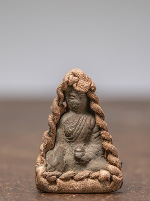 Lot 255 - A SEATED BRONZE BUDDHA IN LEATHER GAU, TIBET, 18TH CENTURY