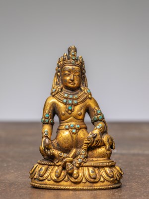 Lot 285 - A SEATED BRONZE GILT JAMBHALA WITH TURQUOISES, TIBET, 18TH CENTURY