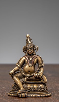 Lot 295 - A SMALL SEATED BRONZE JAMBHALA WITH SILVER AND COPPER INLAYS, TIBET, 18TH CENTURY