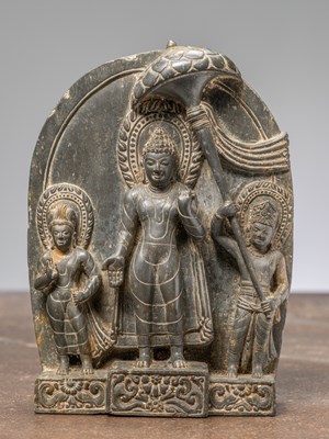Lot 269 - A STANDING STONE BUDDHA WITH CONSORTS, NEPAL , 18TH CENTURY REVIVAL