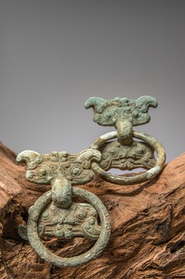 Lot 84 - (R) A PAIR OF BRONZE FITTINGS WITH TAOTIE MASKS, CHINA, WARRING STATES PERIOD, 4TH TO 3RD CENTURY BC