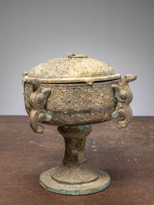 Lot 83 - (R) A CHINESE BRONZE COVERED DOU RITUAL VESSEL ON STEM, EASTERN ZHOU STYLE, 19TH CENTURY