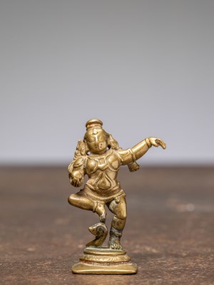 Lot 342 - A SMALL DANCING BRONZE KRISHNA, INDIA, 16TH CENTURY