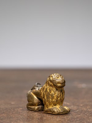Lot 315 - A BRONZE RESTGILT LION, INDIA, 15TH CENTURY