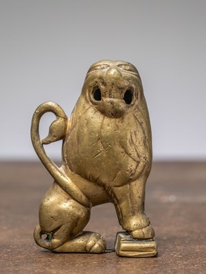 Lot 305 - A SMALL SEATED BRONZE LION, INDIA, 18TH CENTURY