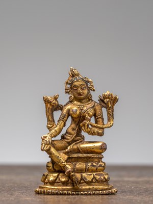 Lot 259 - A GILT-BRONZE FIGURE OF GREEN TARA, TIBET, 18TH CENTURY