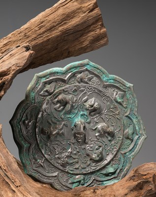 Lot 21 - A CHINESE BRONZE MIRROR WITH MYTHOLOGICAL ANIMALS, HAN DYNASTY