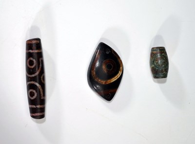 Lot 74 - THREE DZI BEADS